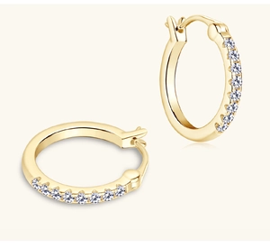 Macro shot of gold-plated moissanite hoop earrings with sparkling zircon inlay