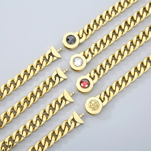 Detailed view of 11mm Cuban chains with crystal-encrusted clasps and a gold skull pendant
