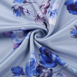 Detailed close-up of light blue rose floral print on summer beach vacation dress fabric