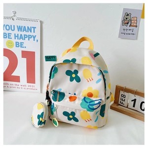 Detail view of a cream canvas kids backpack with floral print and round coin purse attached