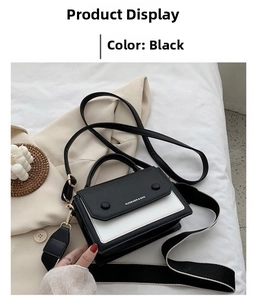 Detail view of black and white contrast small square bag with interchangeable shoulder straps