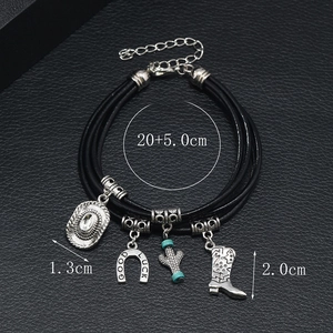 Detail of black multi-layer leather bracelet with Western cowboy charms and Good Luck horseshoe