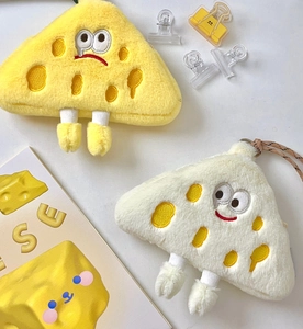 Detail of plush cheese coin purses with cute embroidered expressions and top zipper