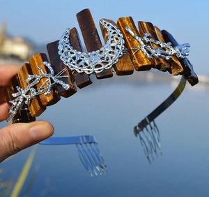 Detail of bohemian tiger eye moon crown with intricate silver branch and leaf filigree