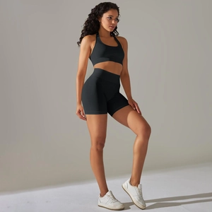 Detail of high-waisted seamless yoga shorts and black ribbed sports bra set for fitness