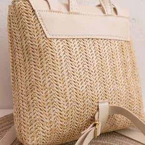 Women's woven backpack with cream leather trim and straw texture for beach vacations