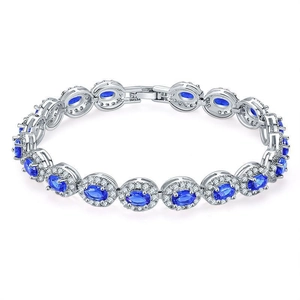 Macro detail of silver bracelet featuring oval blue stones with diamond-like halo accents