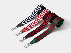 Macro shot of chevron canvas straps with leather ends and silver swivel hooks