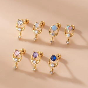 Minimalist stainless steel ear studs with colorful zircon moon and wing designs on beige background