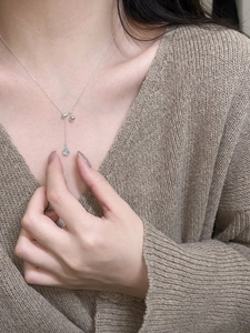 Detail of silver S925 teardrop sapphire pendant necklace shown on model neck