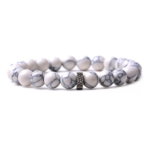 Detail showing white turquoise beaded bracelet with decorative silver metal spacer bead
