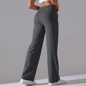 Detail of high-waist wide-leg fitness pants showing lifting effect and sleek dark grey fabric
