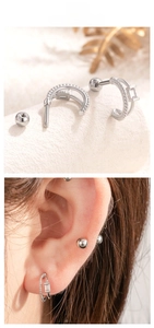 Detail of silver double-layered curved stud earrings with zirconia and screw-back closure
