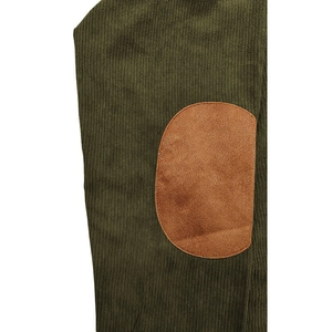 Close-up of olive green knit fabric with a brown oval reinforcement elbow patch