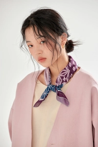 Close-up of floral cotton linen square scarf worn as a stylish neck tie accessory