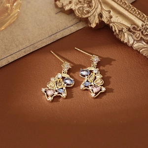 Detailed close-up of golden horse earrings with vibrant multi-colored inlaid gemstones
