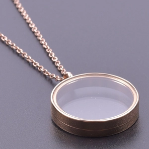 Detailed macro view of a rose gold round floating locket pendant with transparent glass