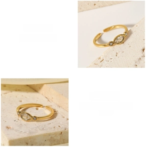 Macro detail of gold adjustable ring with marquise white zircon on stone background