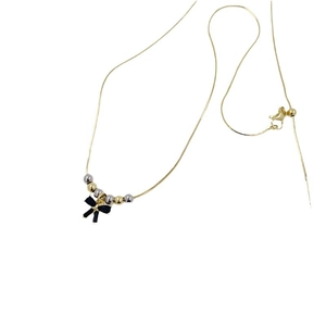 18K gold plated necklace featuring handcrafted beads and a black 3D bow pendant