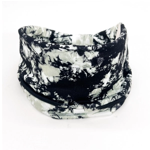 Macro detail of elastic cotton headband featuring black and white tie-dye paisley patterns