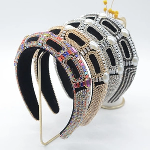 Dettaglio di cerchietti imbottiti con strass colorati, perle e cristalli ricamati a mano
