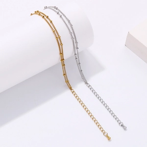 Detail of adjustable double-layer beaded stainless steel chains in gold and silver