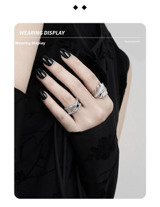 Detail of S925 silver mesh ring with blue zircon and wing engraving on a model