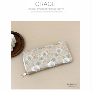 Detailed close-up of long wallet featuring white and gold fan-shaped embroidery patterns