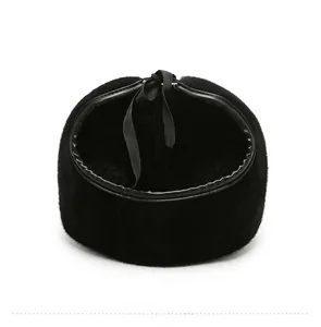 Rear view of faux mink fur winter hat with black silk bow and premium leather piping edge