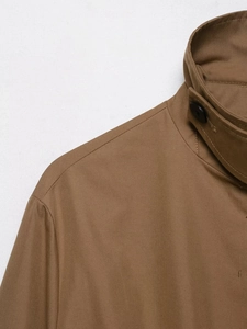 Detail shot of khaki British style parka shoulder with high density stitching and button
