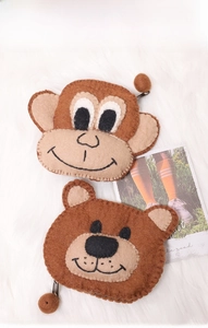 Detail of wool felt animal coin purses with brown monkey and bear designs and zipper