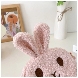 Close-up of pink plush rabbit bag with soft sherpa fleece and cute embroidered details