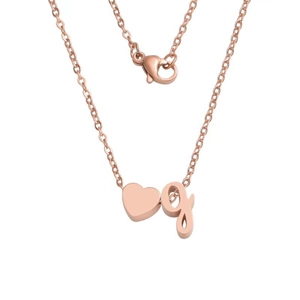 Close-up of rose gold stainless steel heart pendant with letter g on a cable chain