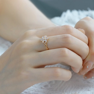 Macro detail of 14K gold plated flower ring with opal petals and micro-pave diamonds
