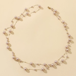 Elegant multi-layered champagne pearl and gold chain long necklace in a spiral layout