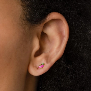 Detail of s925 silver bird stud earring with pink and green enamel and blue eye gem