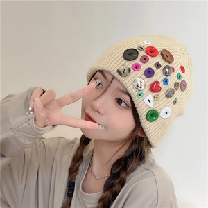Beige knitted beanie with colorful various shapes buttons for a stylish winter look