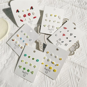 Detailed close-up of colorful resin stud earrings set in various geometric and fruit shapes