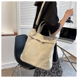 Casual cream nylon tote bag shown in a lifestyle home office setting with spacious design