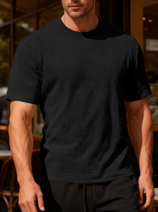 Detail of black slim fit T-shirt showing premium 3D embossed waffle texture fabric