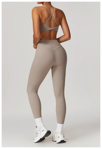 Dettaglio del set yoga kaki con cucitura a V sui glutei e reggiseno sportivo incrociato