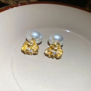 Detail of 18k gold plated pearl flower earring with zircon inlays and petals