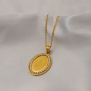 Gold stainless steel oval Virgin Mary necklace with zircon stones on gray background