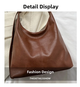 Detail of a brown Hobo bag in glossy retro PU leather with vertical stitching