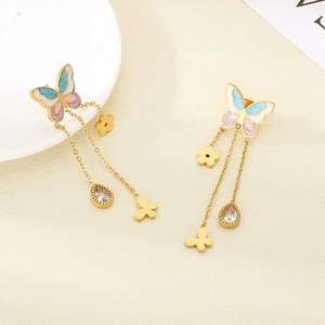 Detailed view of gold butterfly tassel earrings with blue enamel and crystal water drops