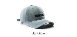 Detail of light blue washed denim baseball cap featuring black CONQUER embroidery