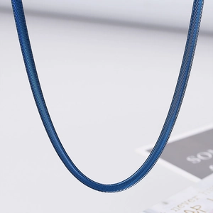 Detailed view of a 5mm blue stainless steel flat snake chain necklace with metallic luster