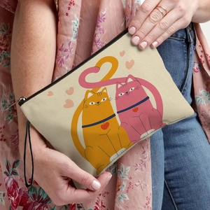 Canvas makeup bag featuring orange and pink cartoon cats forming a heart shape with tails