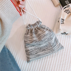 Close-up of woven cotton linen drawstring bag for makeup and jewelry storage