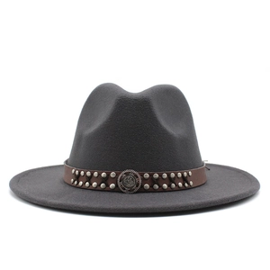 Detail of dark grey fedora hat with brown leather band and silver metal studs